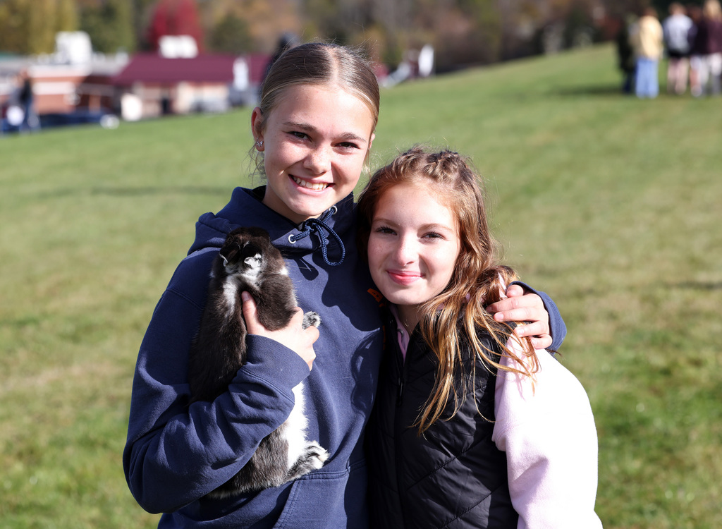 Students interacting with others and animals at the FFA Fair. 