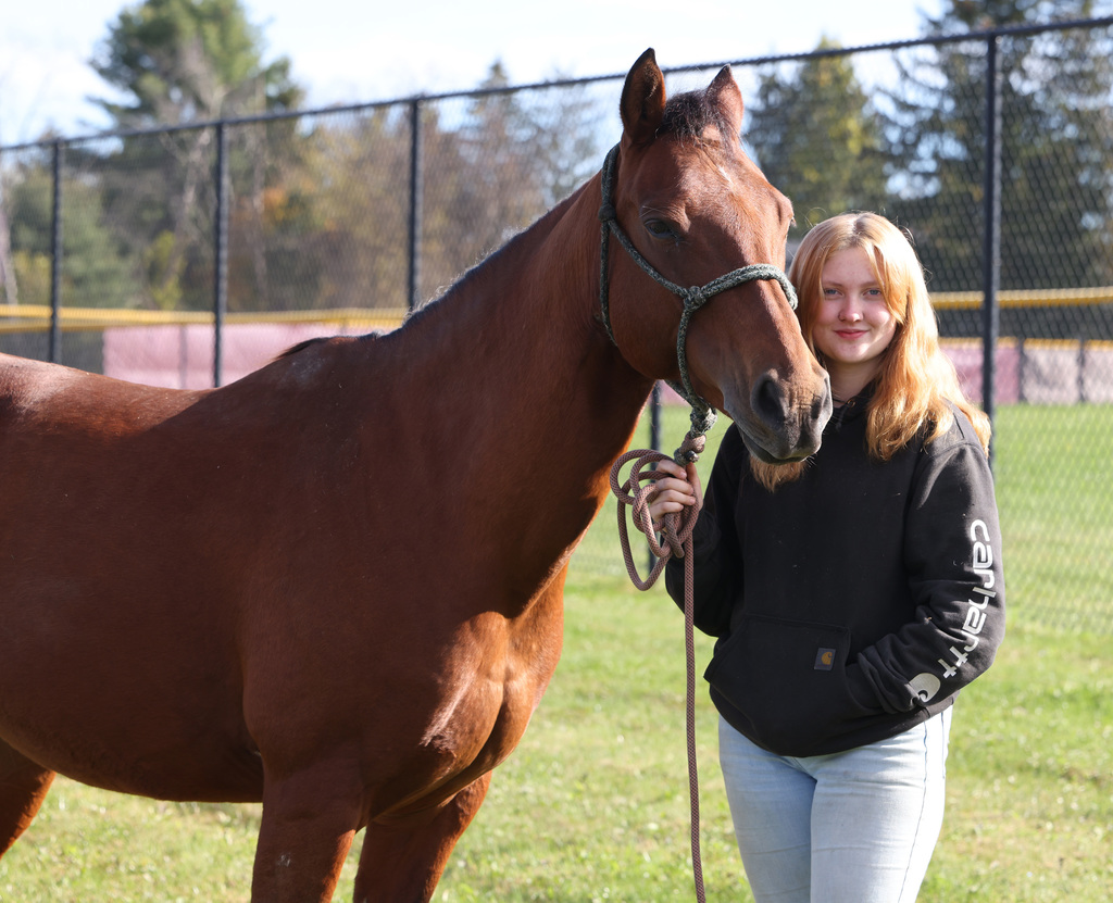 Students interacting with others and animals at the FFA Fair. 
