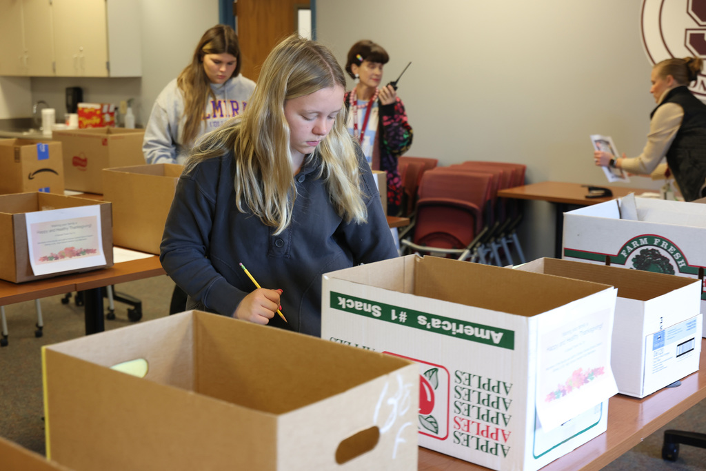 InterAct students helping pack Thanksgiving Day boxes.