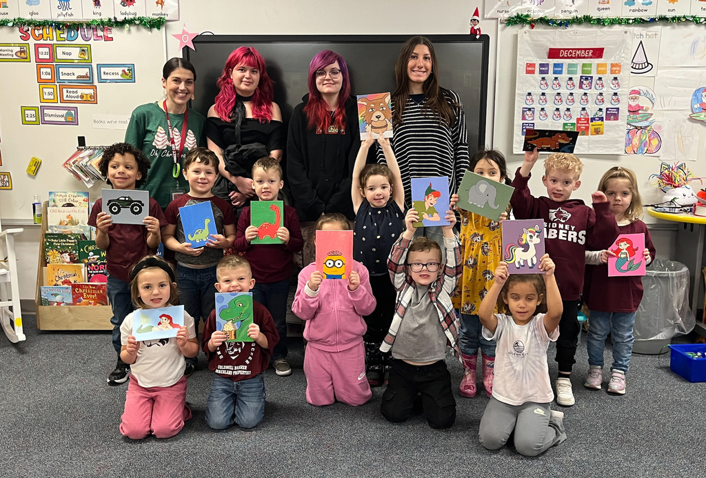 Painting class students with UPK students and their artwork