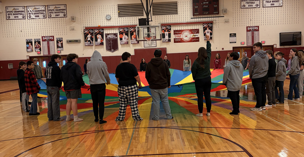 Middle school students taking part in the parachute activity during PE class