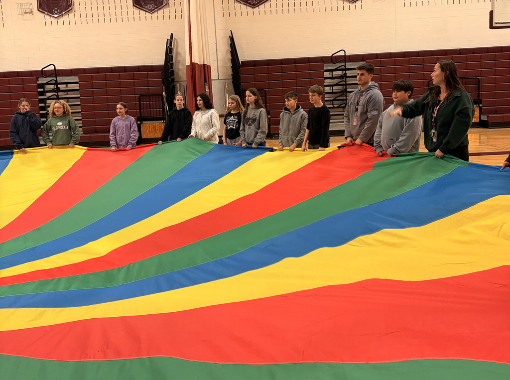 Middle school students taking part in the parachute activity during PE class