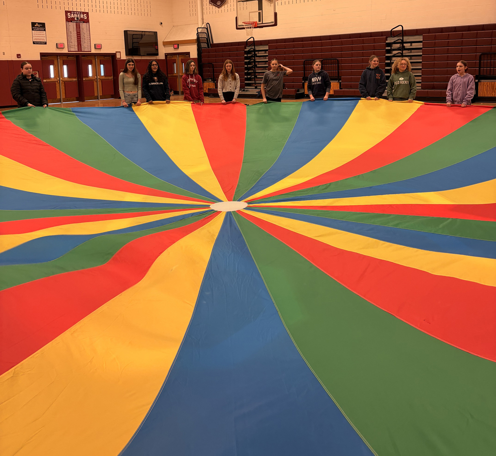 Middle school students taking part in the parachute activity during PE class