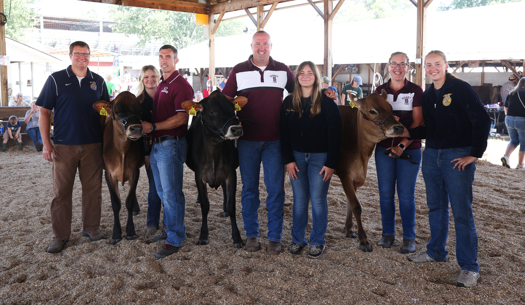 Administrators and students during the FFA Day, showing cows.