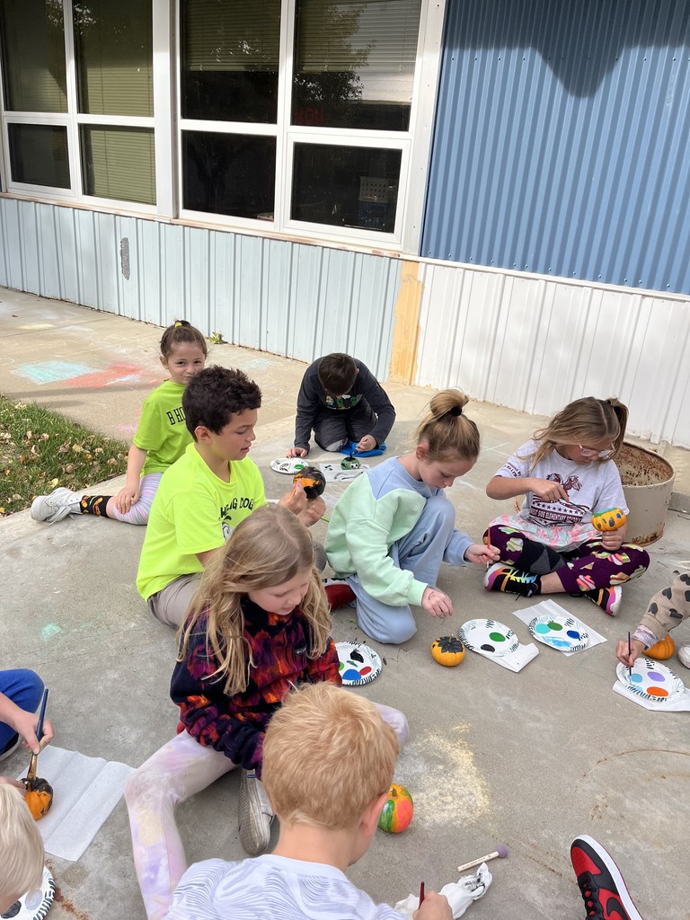 2nd graders painting pumpkins