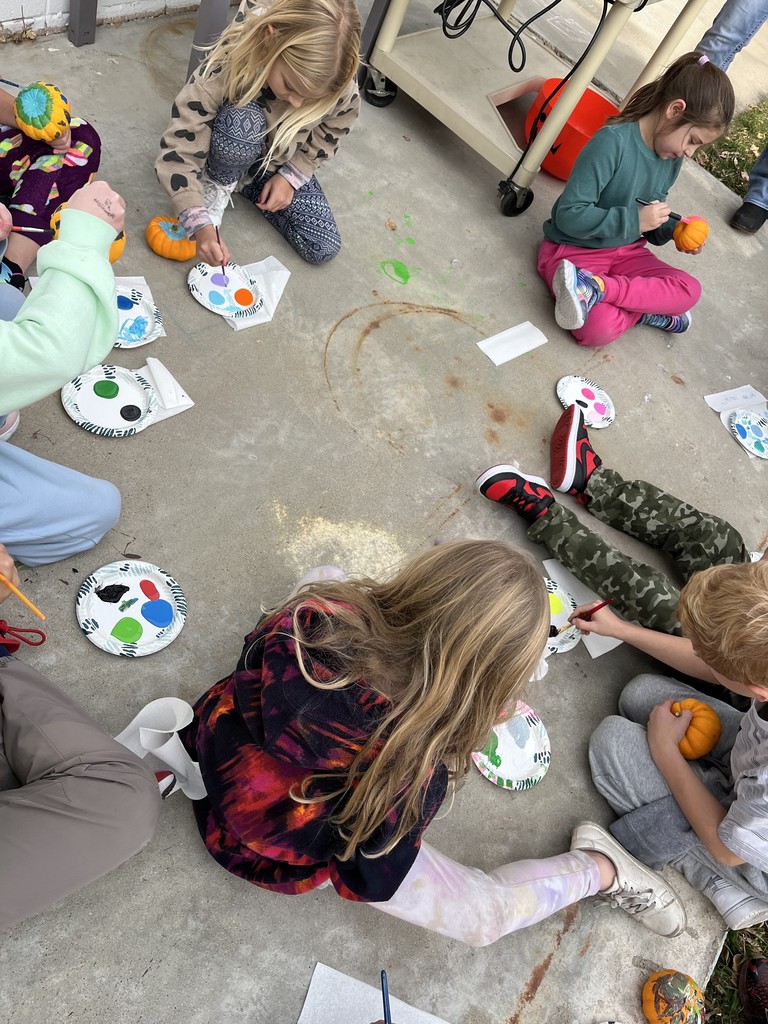 2nd graders painting pumpkins