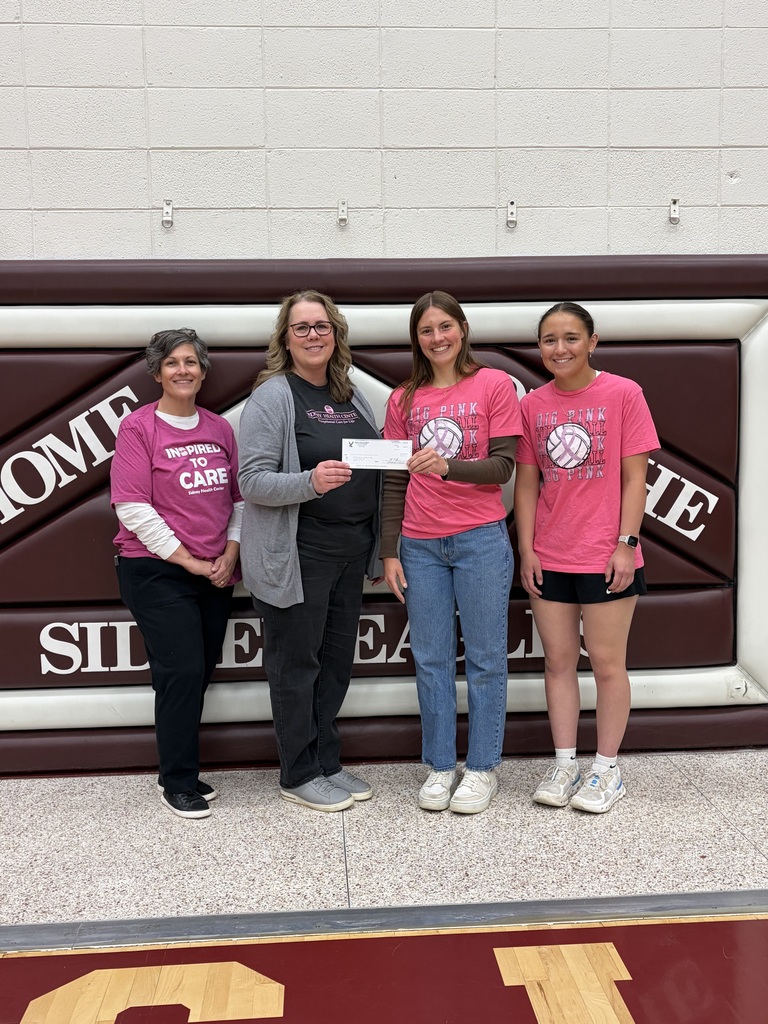 Ave Norby and Aiyana Kirn presented check to reps from the Cancer Center and Cancer Coalition