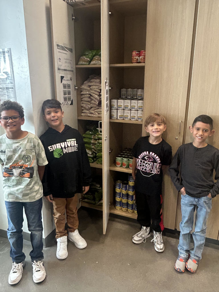 Students standing in front of a food pantry cabinet