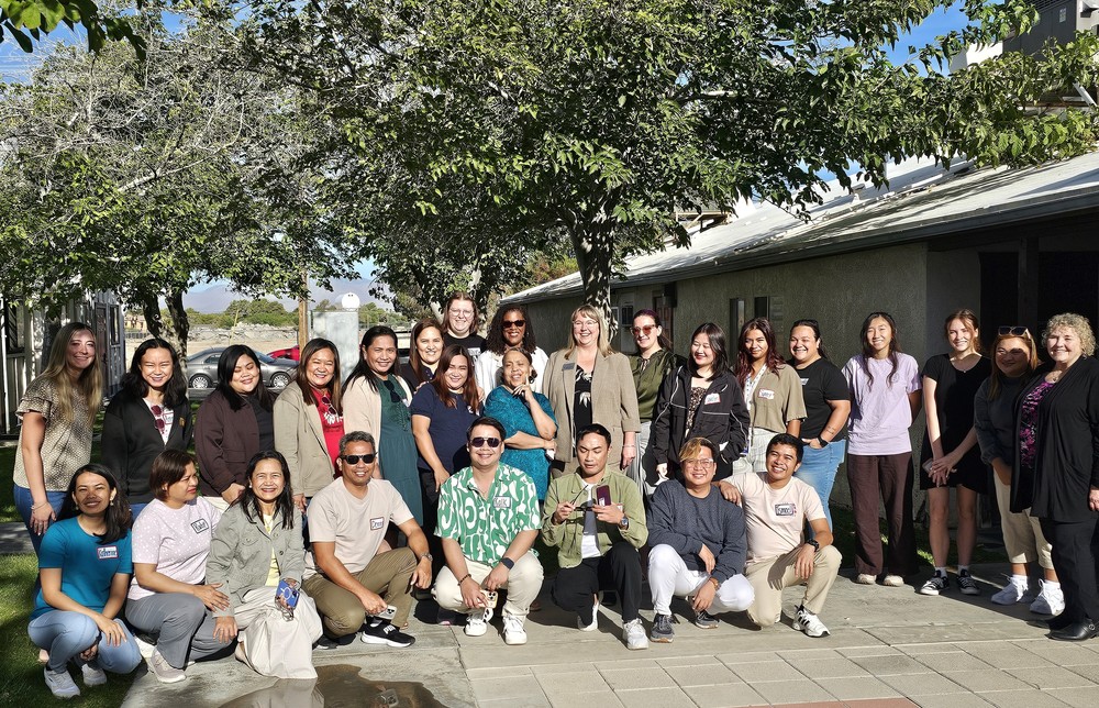 Staff in training pose as a group