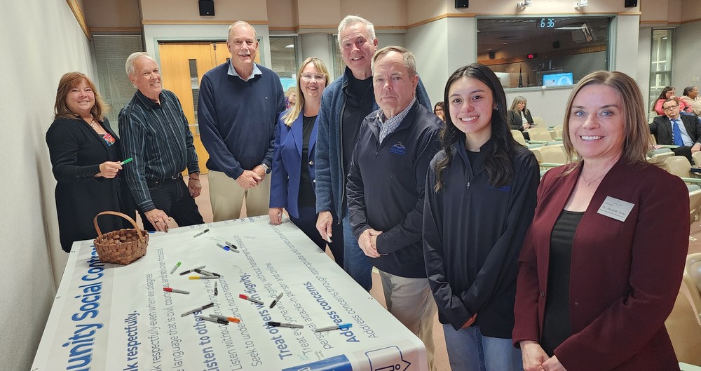 Board, Superintendent, and Deputy Superintendent around Social Contract banner