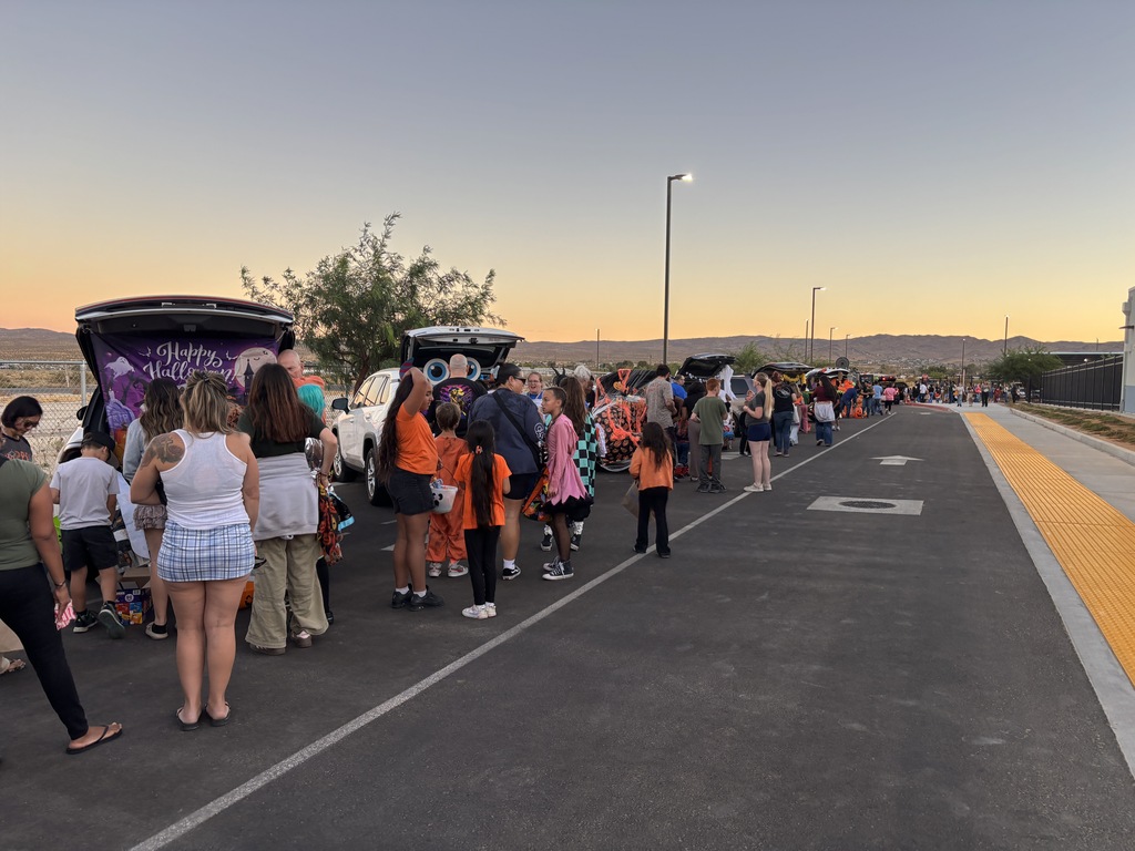Trunk or Treat Car line with familes and the sun setting