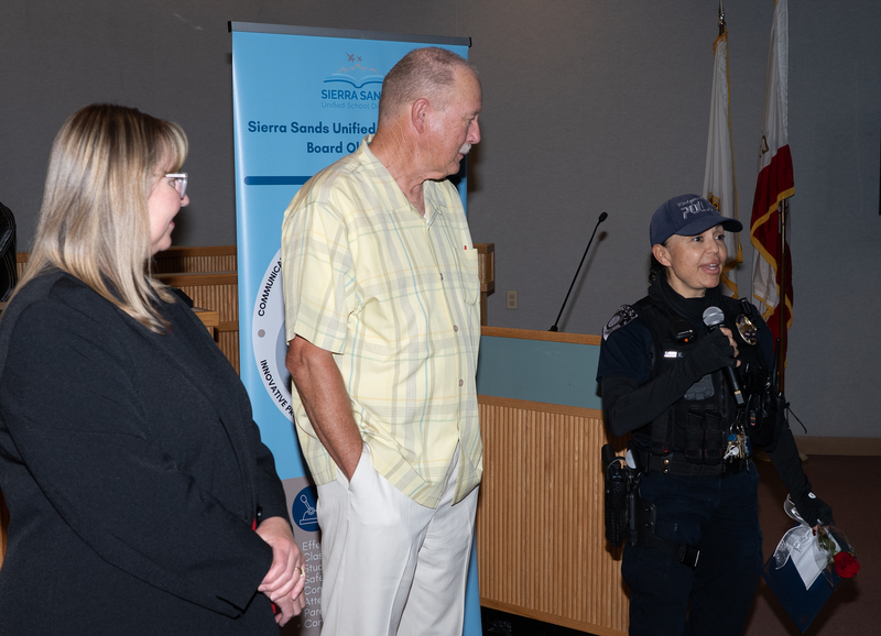 Officer Franco speaking, with Superintendent Moore and President Campbell