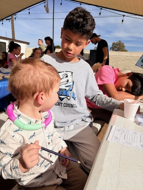 PDS StuCo helping a student write a letter to Santa. 