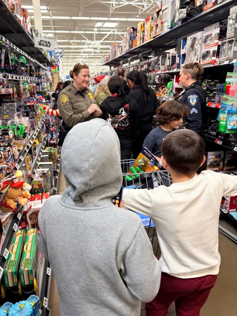 PDS and HM Student Council assisting children shop by helping with picking out gifts and keeping track of spending. 