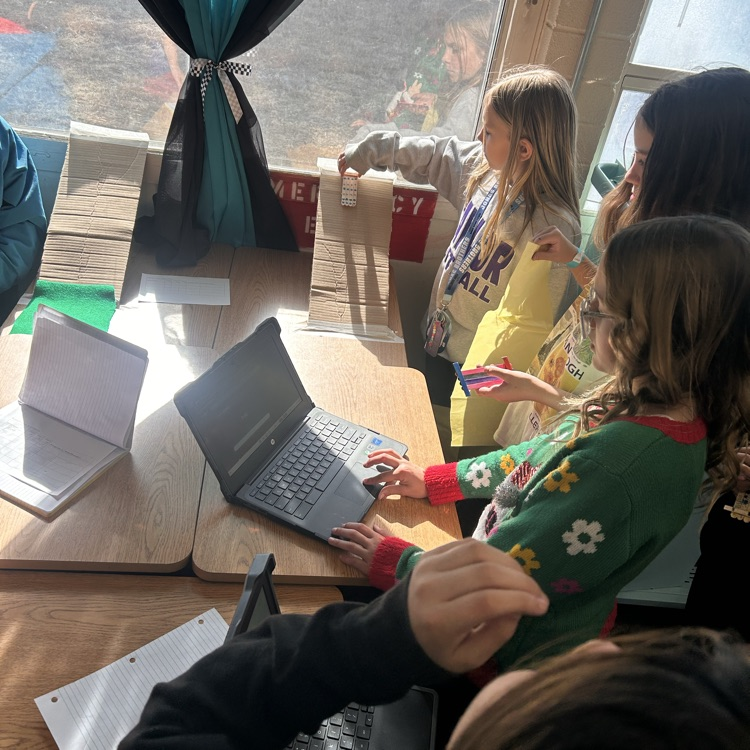 5th grade students testing different variables to create less friction.