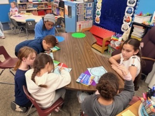 StuCo and Kinder working on building snow globes.