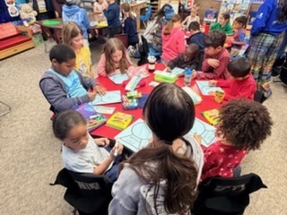 StuCo and Kinder working on building snow globes.