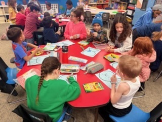 StuCo and Kinder working on building snow globes.