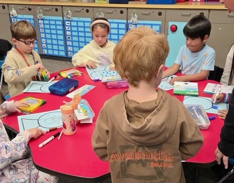StuCo and Kinder working on building snow globes.