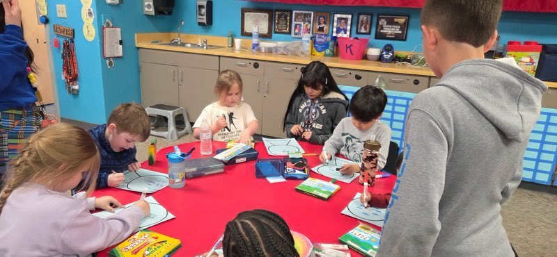 StuCo and Kinder working on building snow globes.