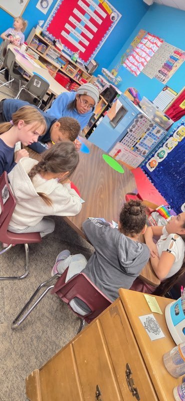 StuCo and Kinder working on building snow globes.