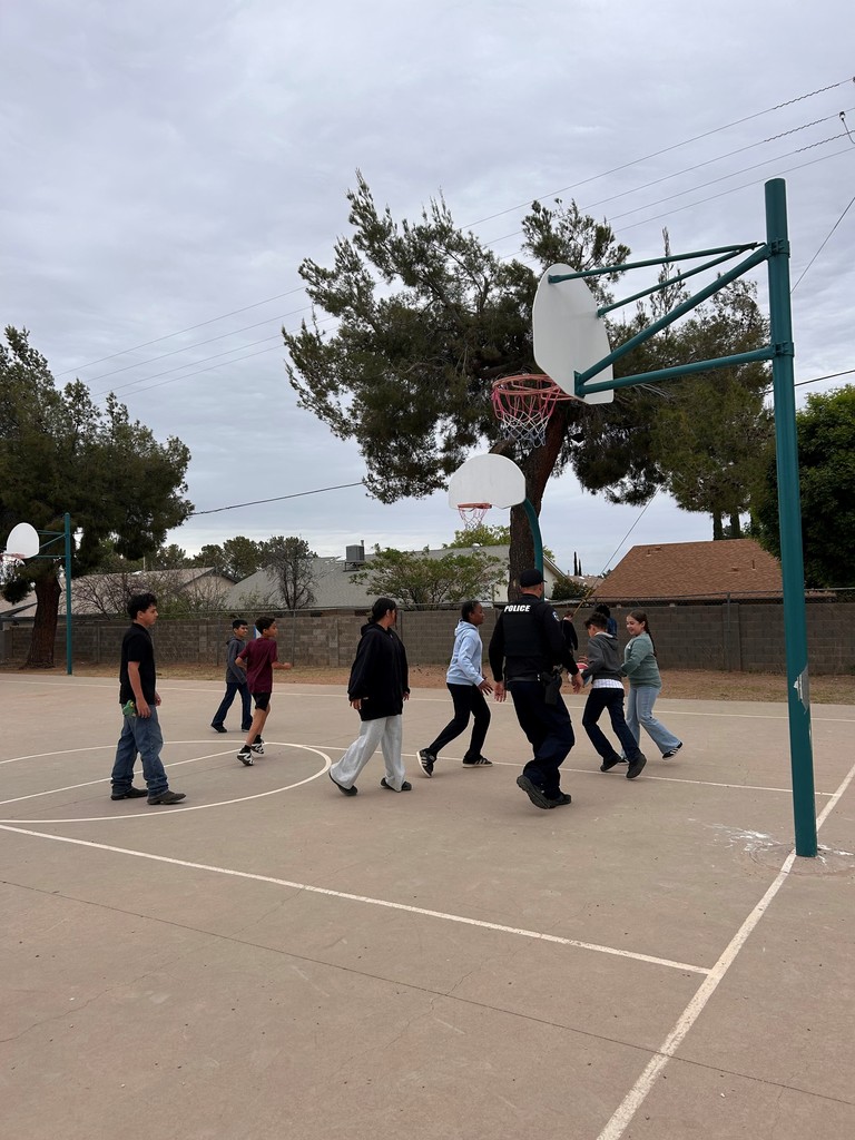 Students take a break from AASA to play basketball with Officer Clark. 