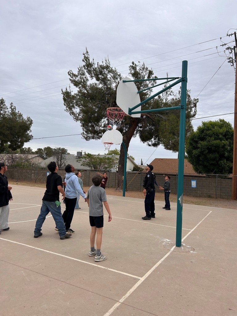 Students take a break from AASA to play basketball with Officer Clark. 