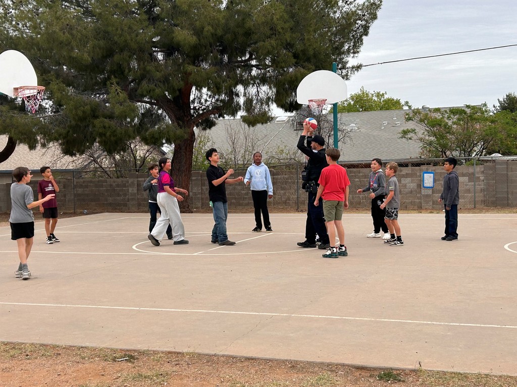 Students take a break from AASA to play basketball with Officer Clark. 