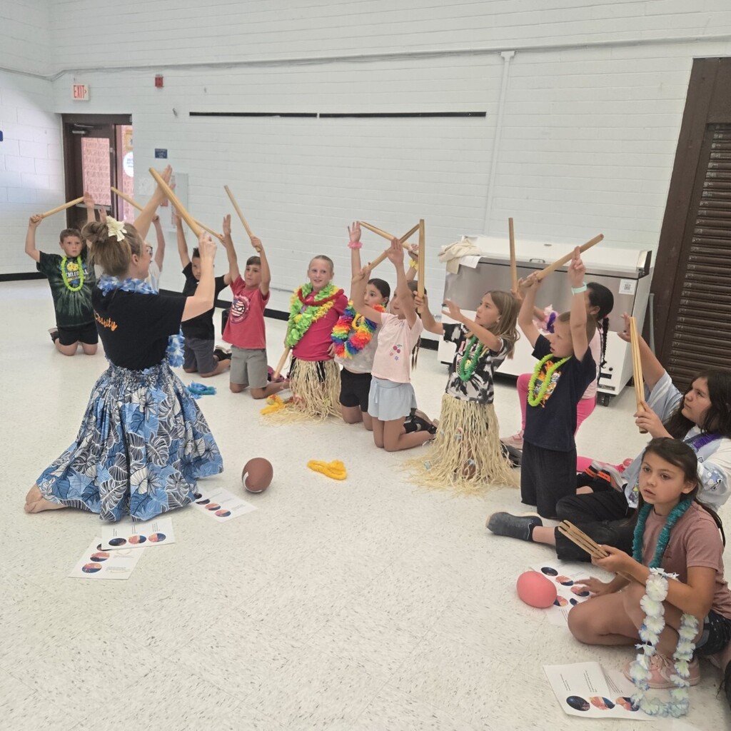 Students learning how to use Hawaiian instruments.