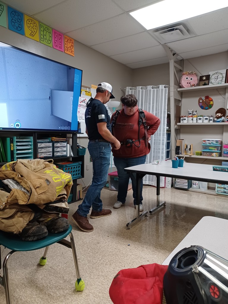 student trying on fire gear
