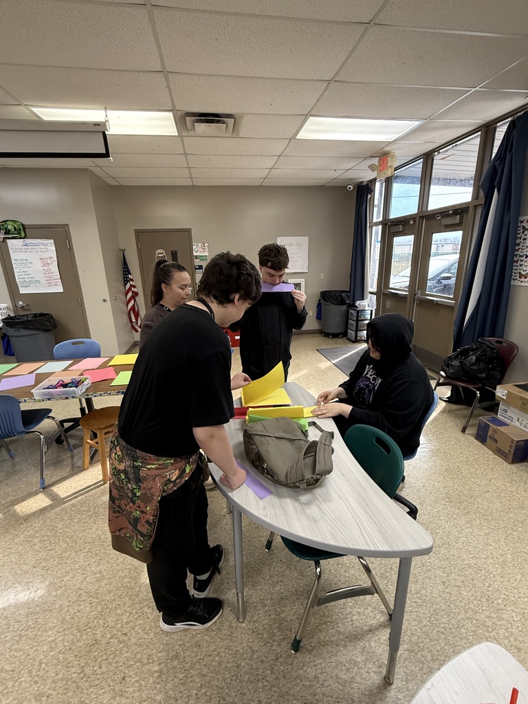 high school students and staff working on art project