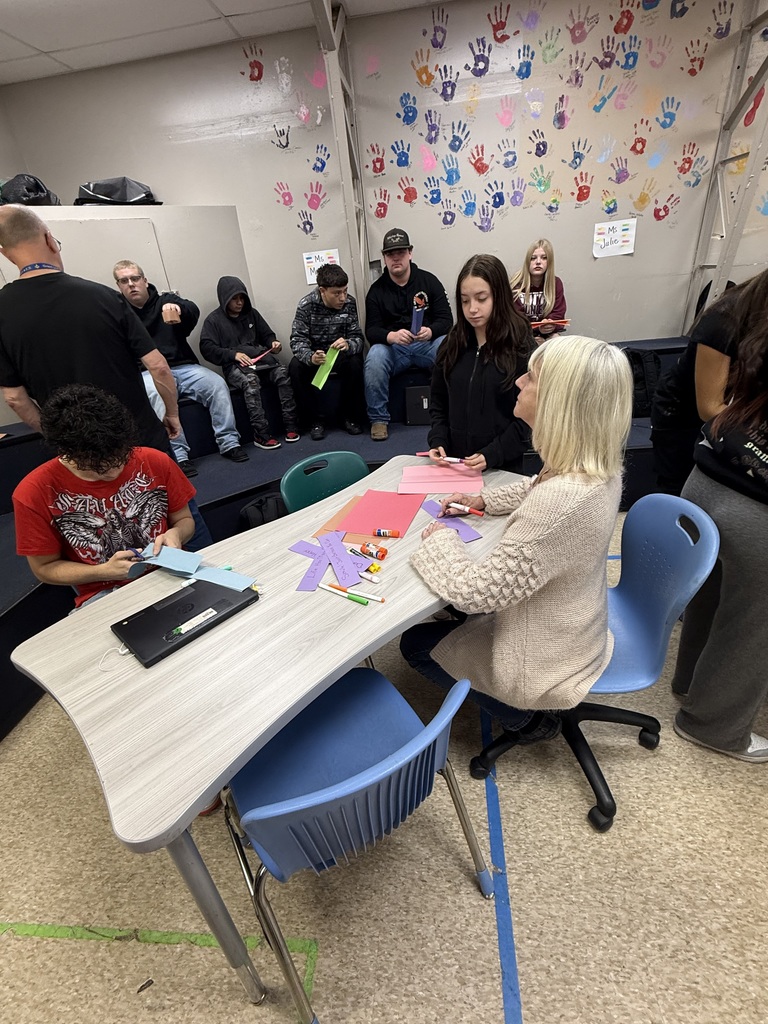 high school students and staff working on art project