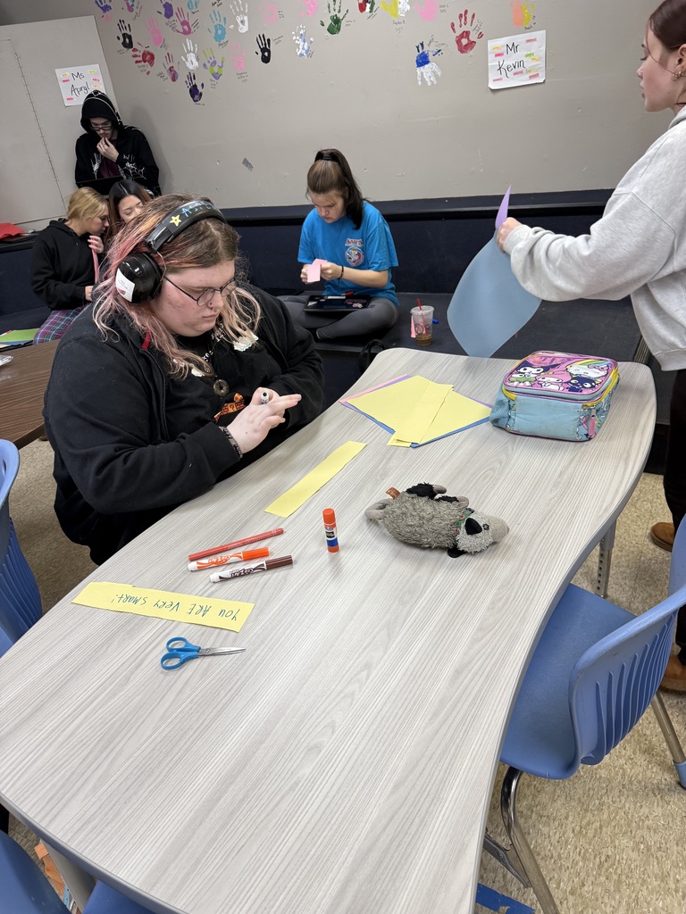 high school student working on art project