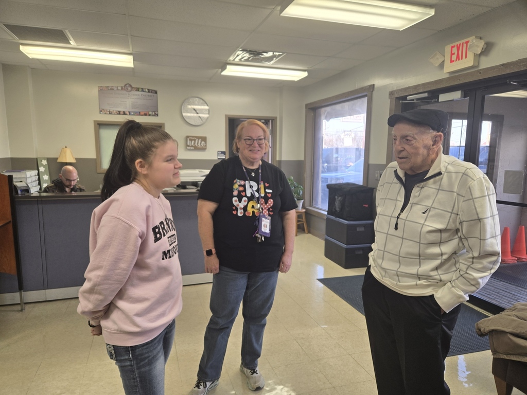 former school employee visiting with current student and staff