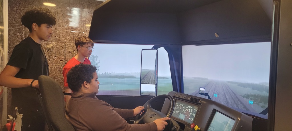 students in a driving simulator