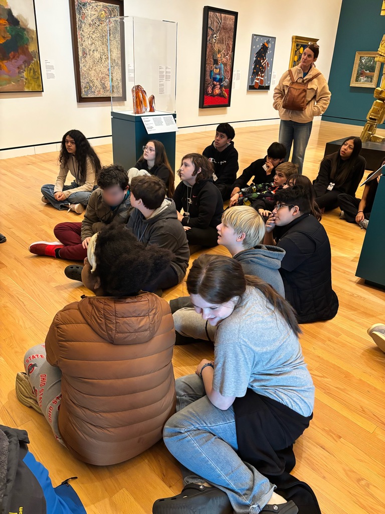 students studying art work