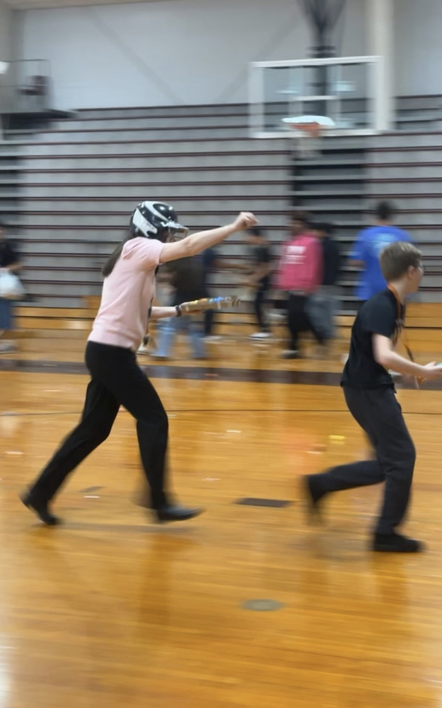teacher chasing student with a confetti egg