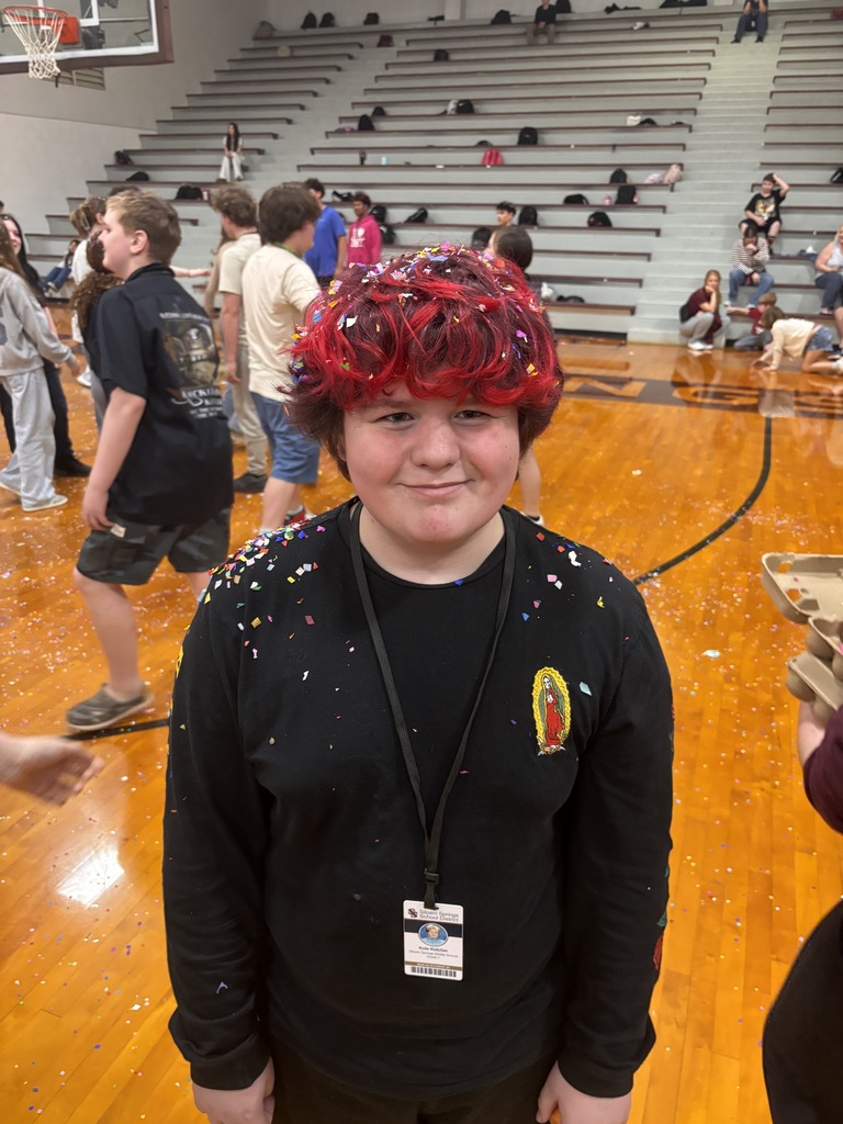 student with confetti smashed on his head
