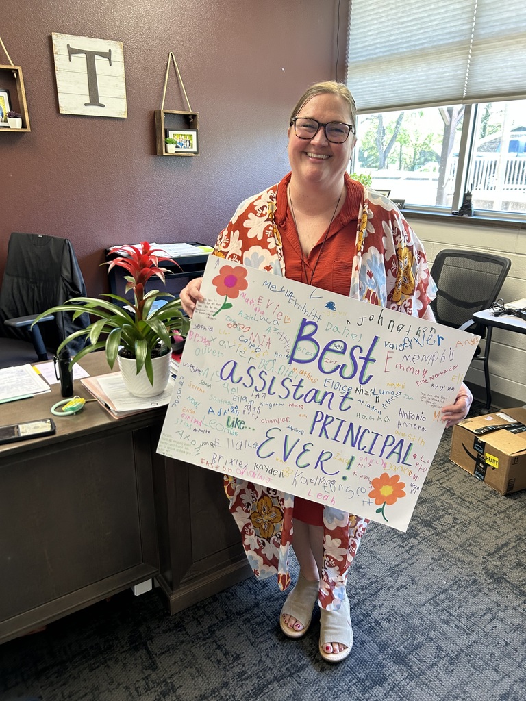 Asst principal with sign