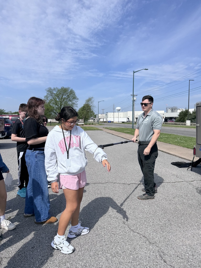 Animal shelter employee demonstrating equipment