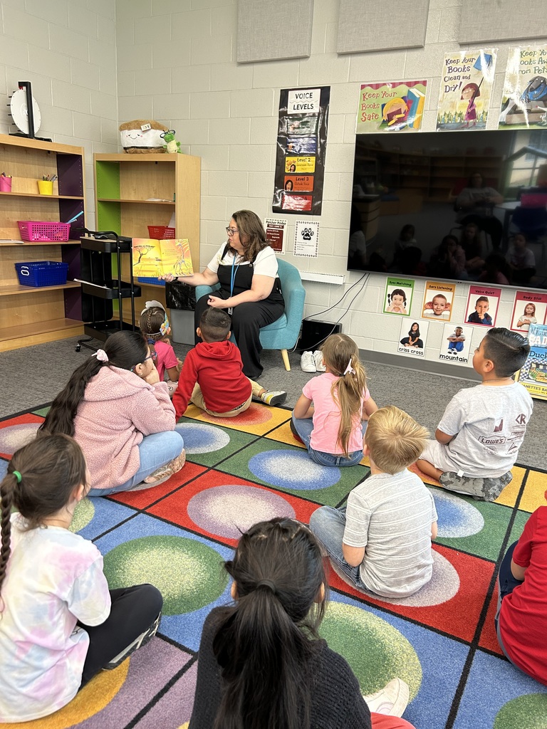 Mrs. Smith reading a book to a classroom of kindergarten students