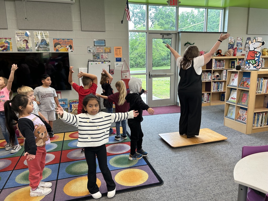 Mrs. Smith dancing with a class of kindergarten students