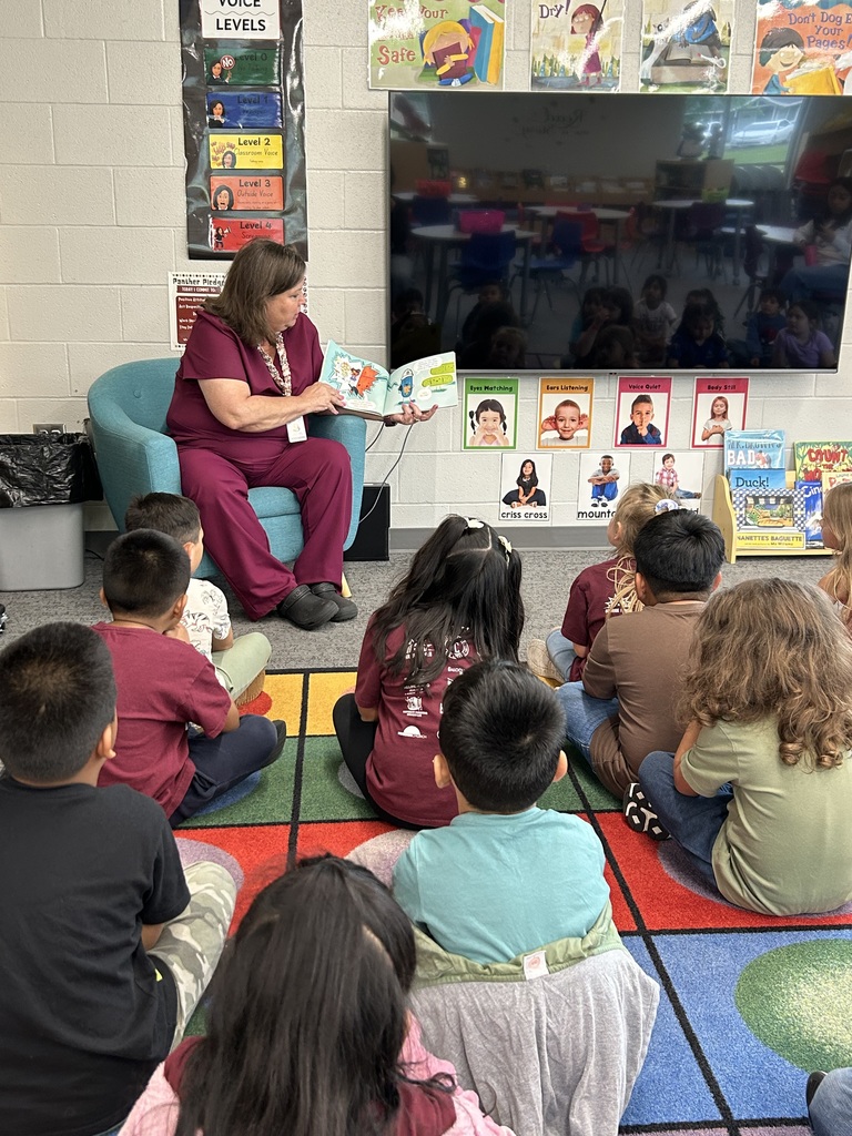 Mrs. Williams reading a book to a class of kindergarten students