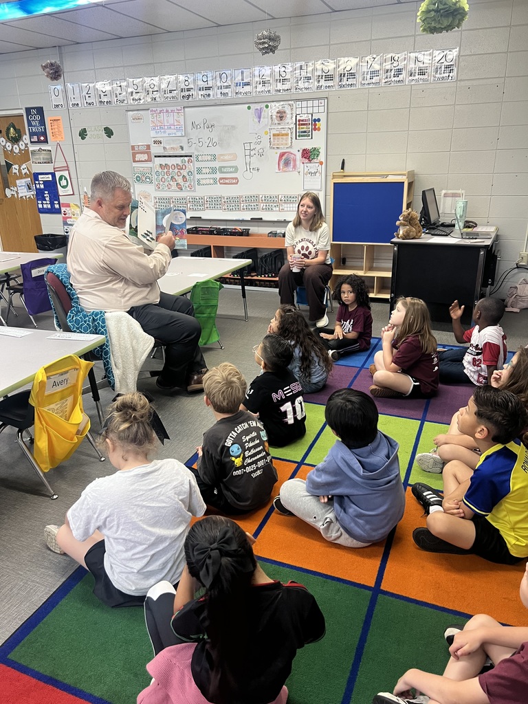 Mr. Schoonover reading a book to a class of kindergarten students