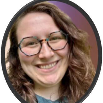 A woman with curly hair wearing colorful glasses, smiling with teeth showing. Background is purple and black.