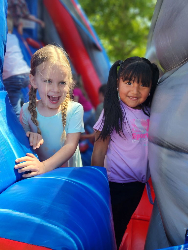 students playing in a bounce house