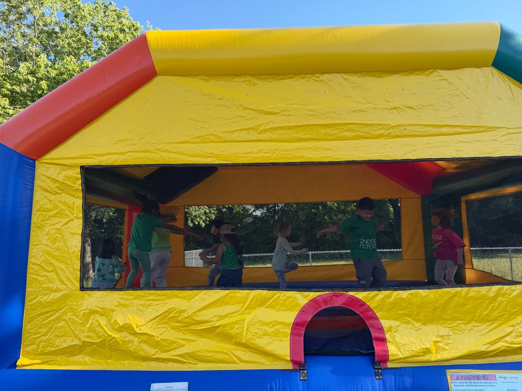 students bouncing in a bounce house