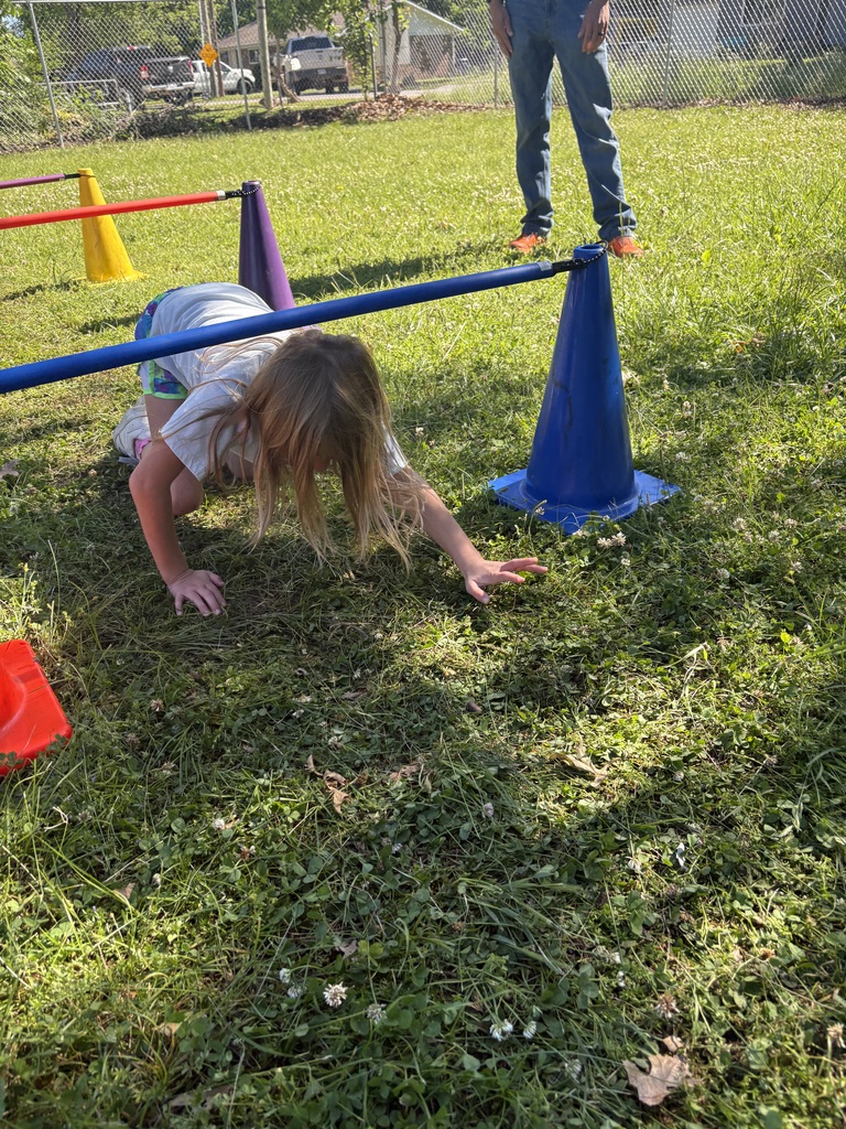 student crawling through an obstacle course