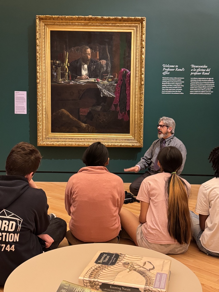 a Crystal Bridges instructor talking to students about a painting