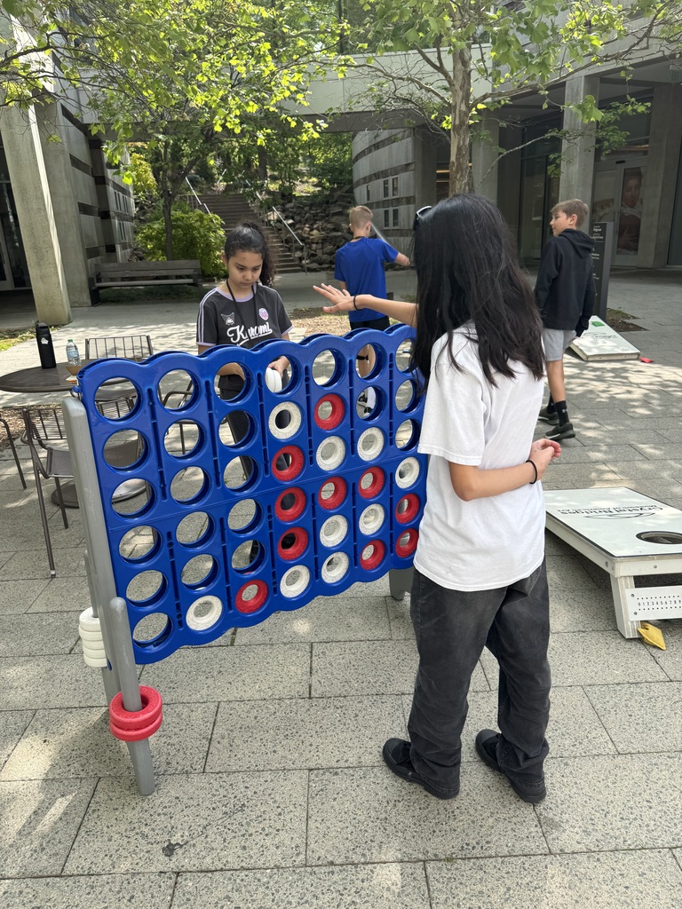 students playing connect four in the outdoor area of Crystal Bridges